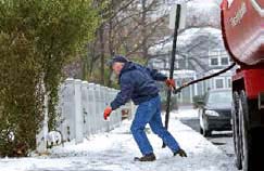 Photo: Winter: Heating man walking across icy sidewalk